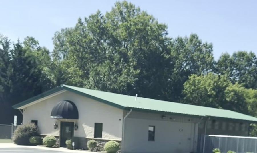 The Canine Carolina building, set back in the trees off Highway 127